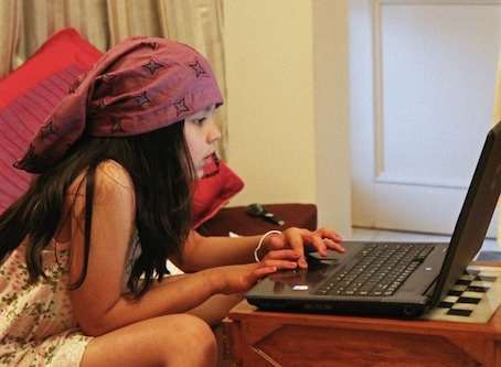 girl sitting and looking at the laptop
